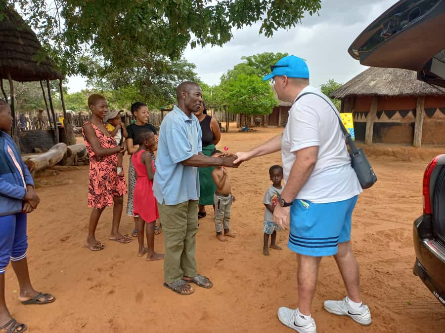 Victoria Falls: Village Life Experience - Joining in with maize stamping